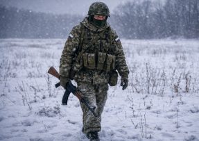 Ruský voják kráčí přes otevřené pole